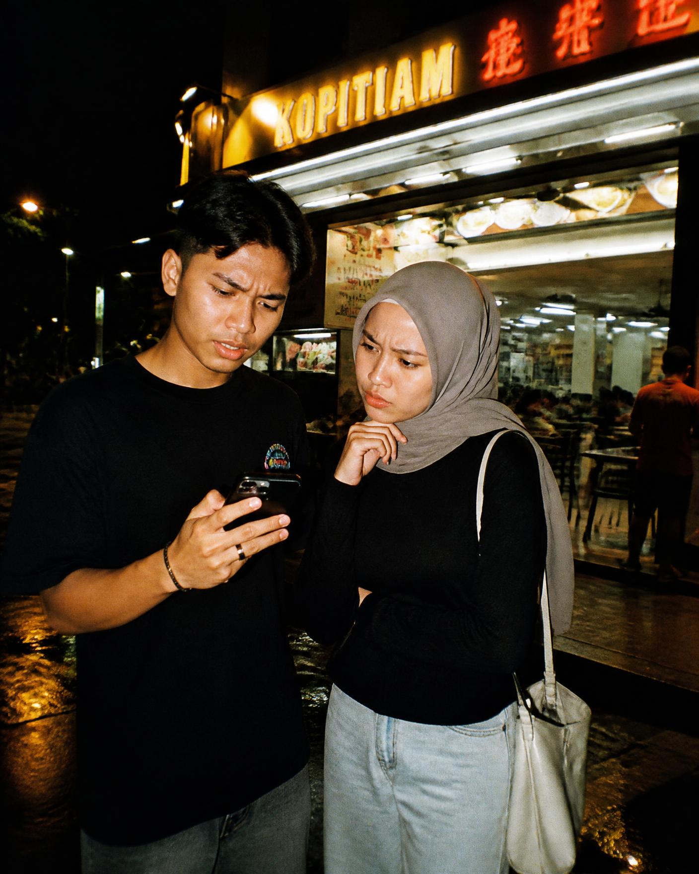 Two people trying to decide where to eat outside a local restaurant
